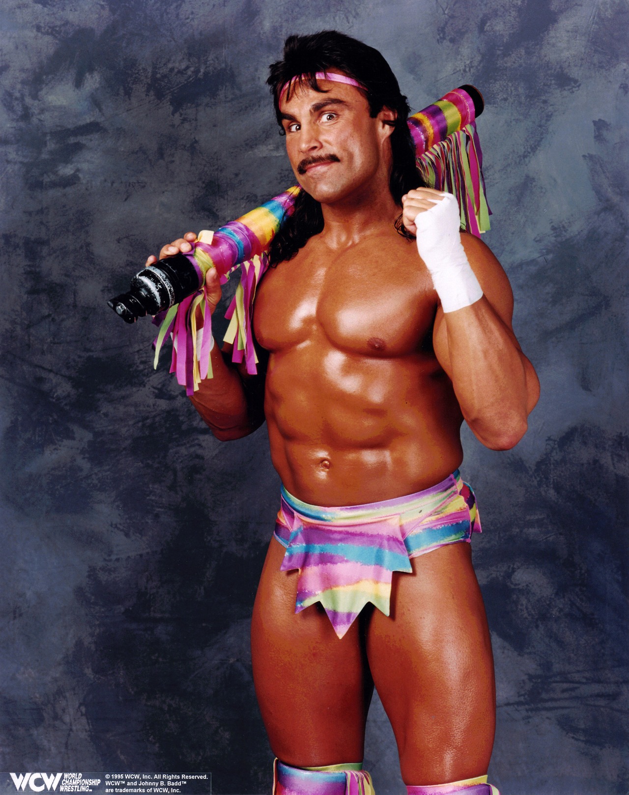 Johnny B. Badd posing in pink and blue trunks
